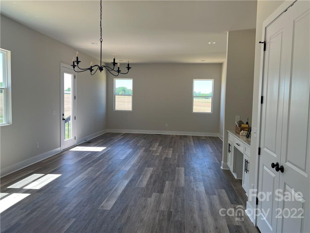 5817 Laney Rogers Road, Unit 5 Monroe, NC 28112 - Photo 5 of 14 a view of an empty room with wooden floor and a window