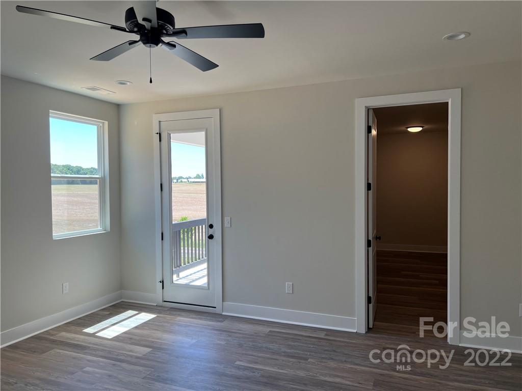 5817 Laney Rogers Road, Unit 5 Monroe, NC 28112 - Photo 8 of 14 a view of an empty room with wooden floor and a window