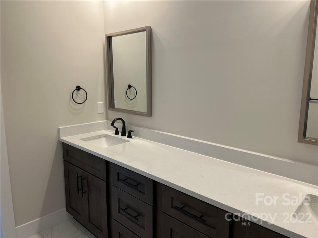 5817 Laney Rogers Road, Unit 5 Monroe, NC 28112 - Photo 9 of 14 a bathroom with a sink and a mirror