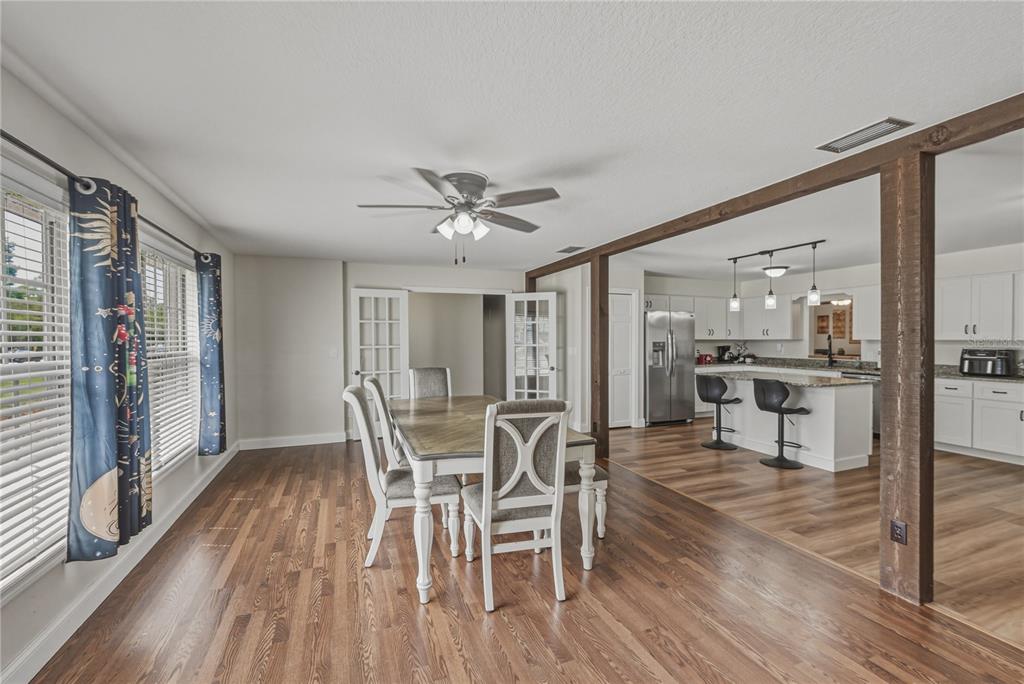609 West Pipkin Road Lakeland, FL 33813 - Photo 22 of 72 a view of a dining room with furniture and wooden floor