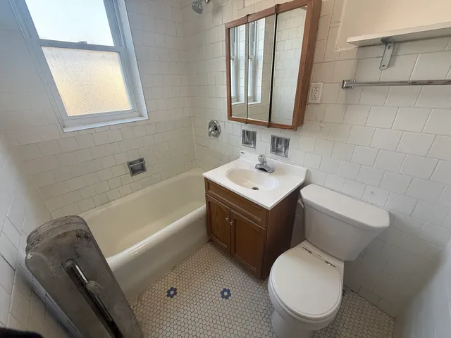 a bathroom with a sink toilet vanity and bathtub