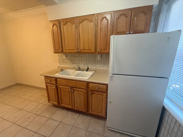 a kitchen with a refrigerator and a sink