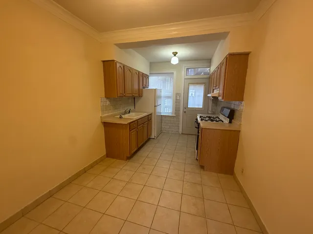 a kitchen with stainless steel appliances a refrigerator sink and microwave