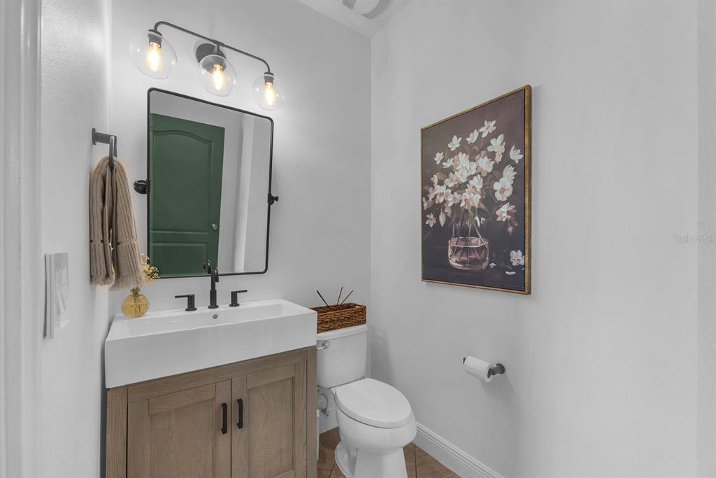 5310 Fishhawk Ridge Drive Lithia, FL 33547 - Photo 28 of 52 a bathroom with a toilet a sink and mirror