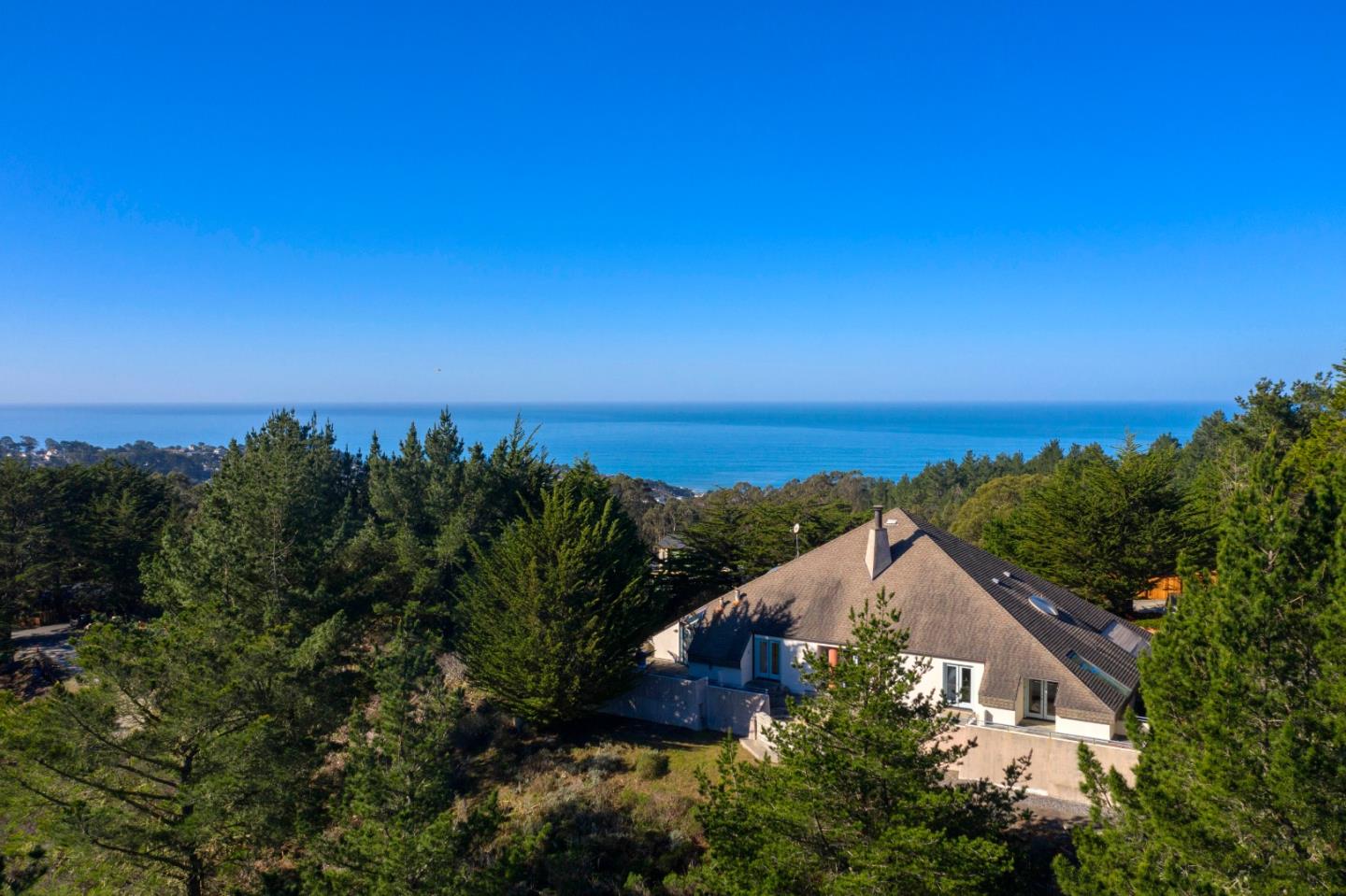 an aerial view of a house with a yard and lake view