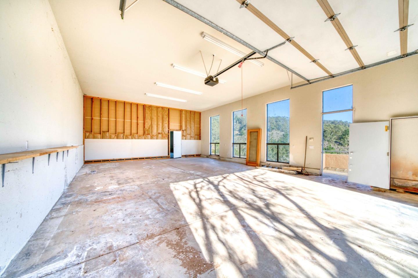 775 Alta Vista Road Montara, CA 94037 - Photo 25 of 27 a view of a bedroom with a bed and large windows