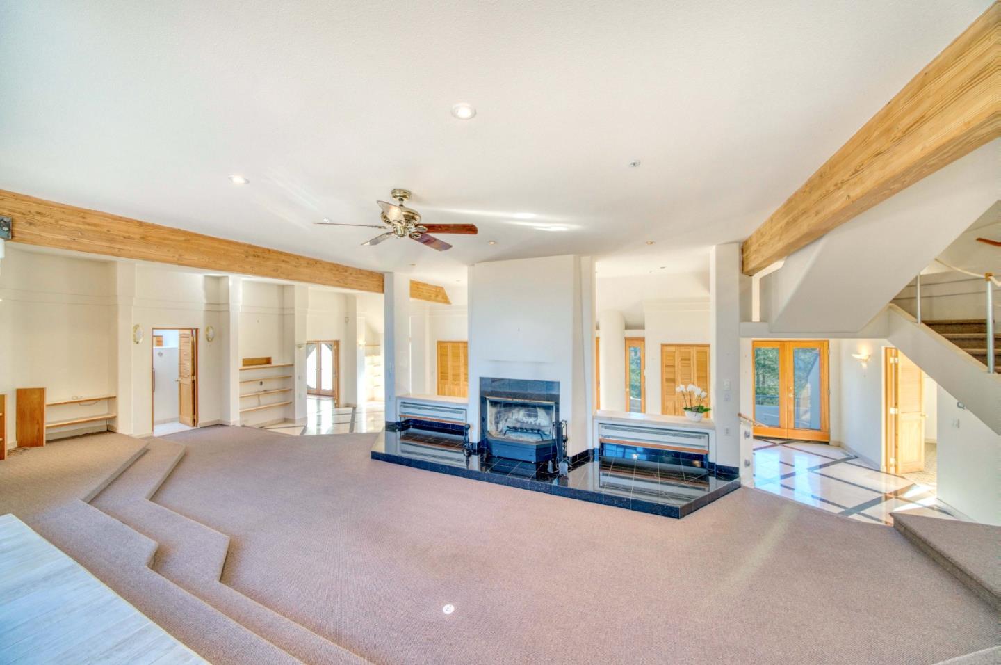 775 Alta Vista Road Montara, CA 94037 - Photo 10 of 27 a spacious bedroom with a large bed and a chandelier