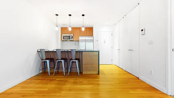 a view of kitchen with furniture and wooden floor