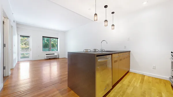 a kitchen with stainless steel appliances granite countertop a stove and a refrigerator