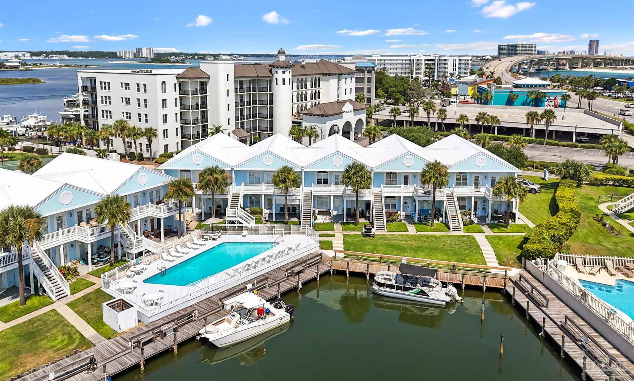 a swimming pool with outdoor seating and yard
