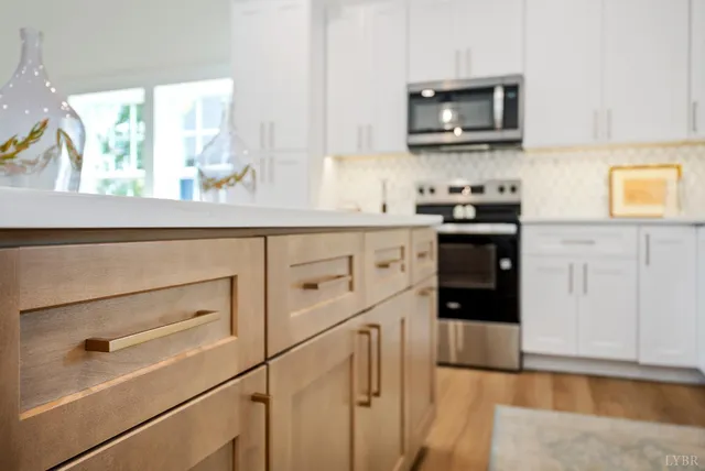 a kitchen with white cabinets and appliances