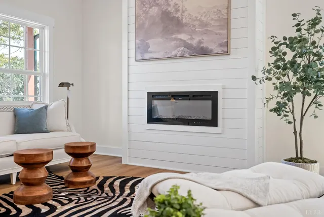 a living room with furniture and a fireplace