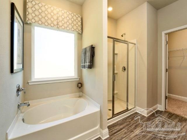 5636 Blake Lane Milton, FL 32571 - Photo 11 of 27 a bathroom with a bathtub and a shower