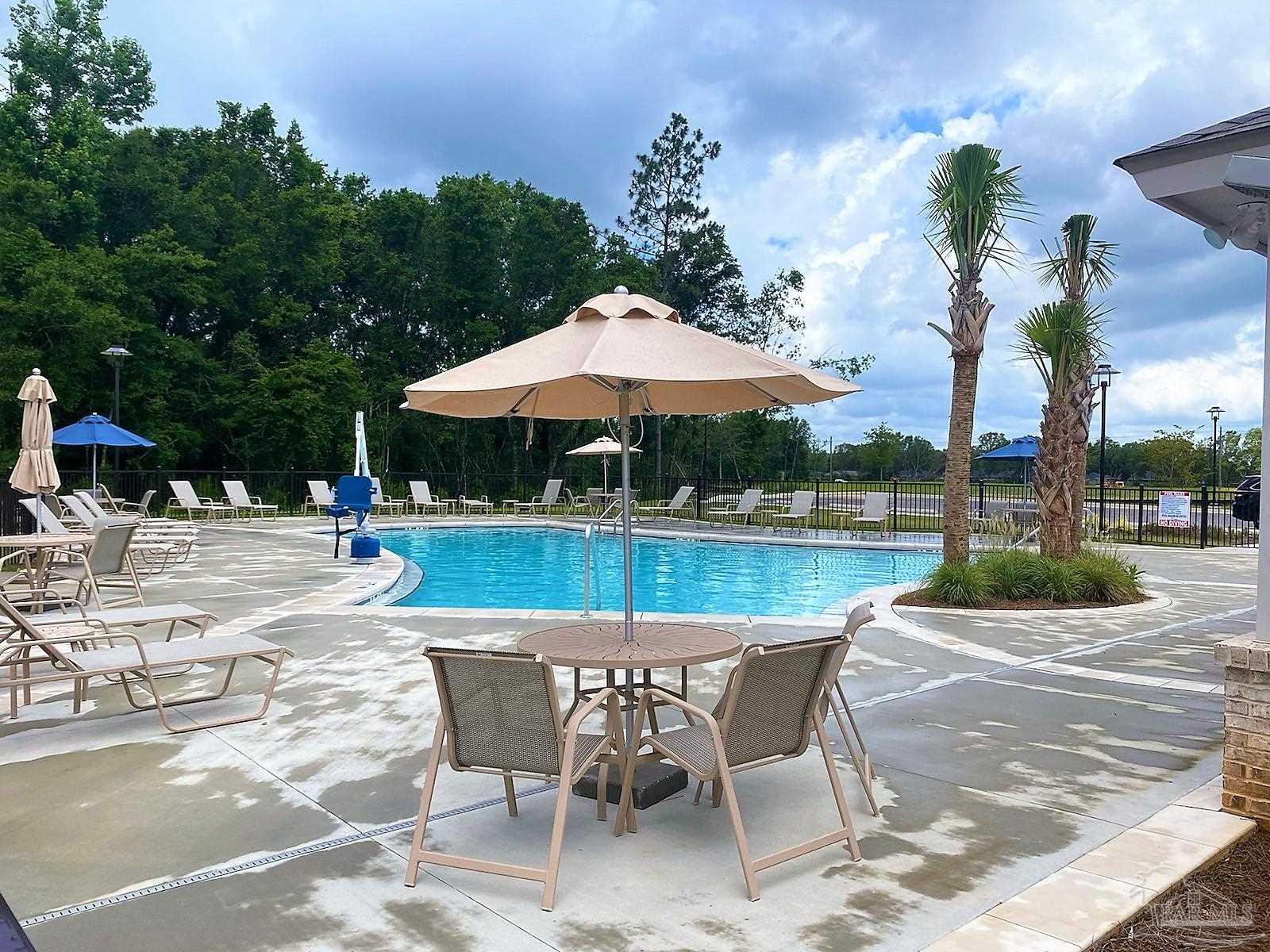 5636 Blake Lane Milton, FL 32571 - Photo 17 of 27 a patio with a table and chairs