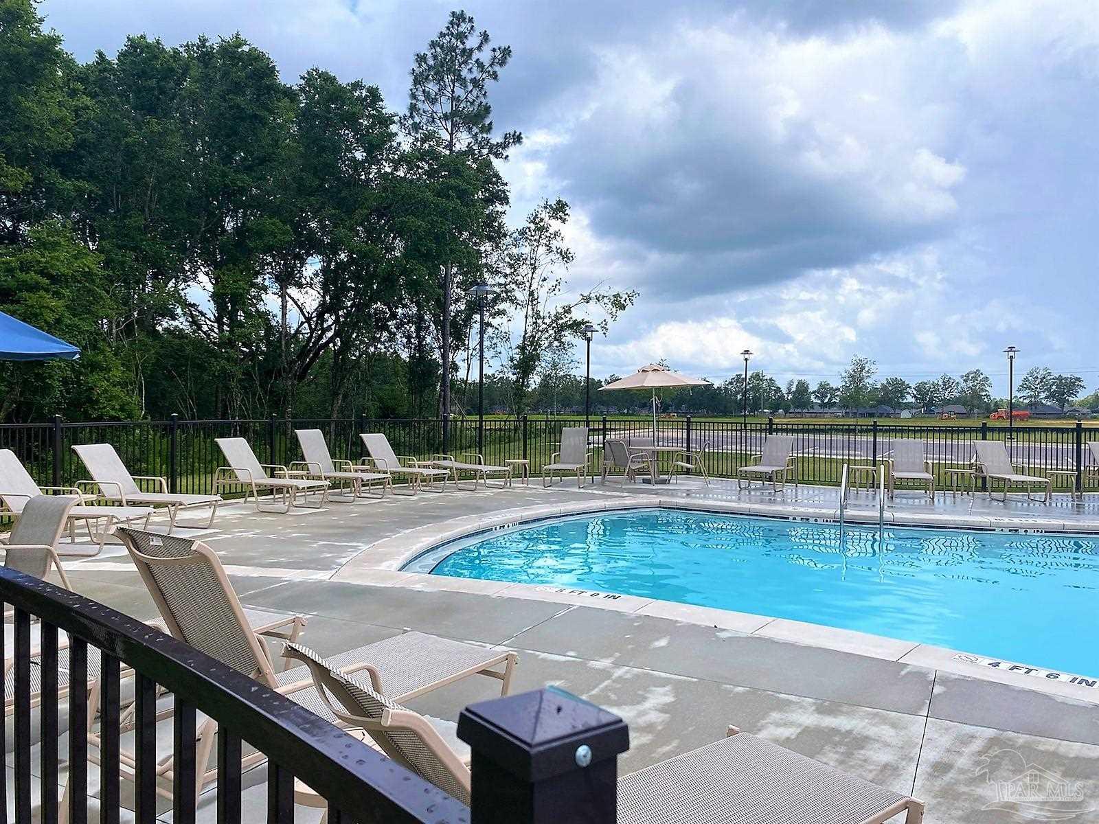 5636 Blake Lane Milton, FL 32571 - Photo 18 of 27 a view of a swimming pool with a lounge chair