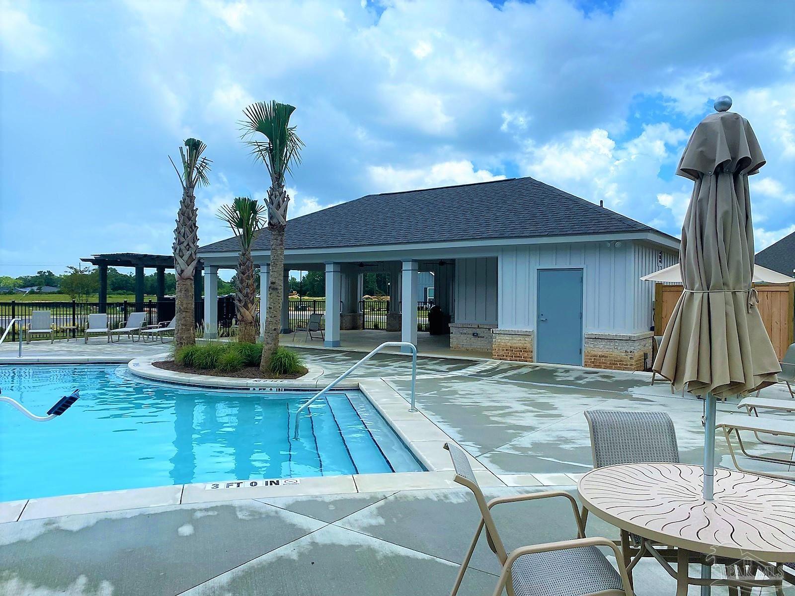 5636 Blake Lane Milton, FL 32571 - Photo 19 of 27 a view of a house with backyard swimming pool and sitting area