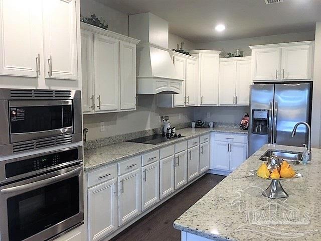5636 Blake Lane Milton, FL 32571 - Photo 4 of 27 a kitchen with stainless steel appliances granite countertop a stove a sink and a microwave