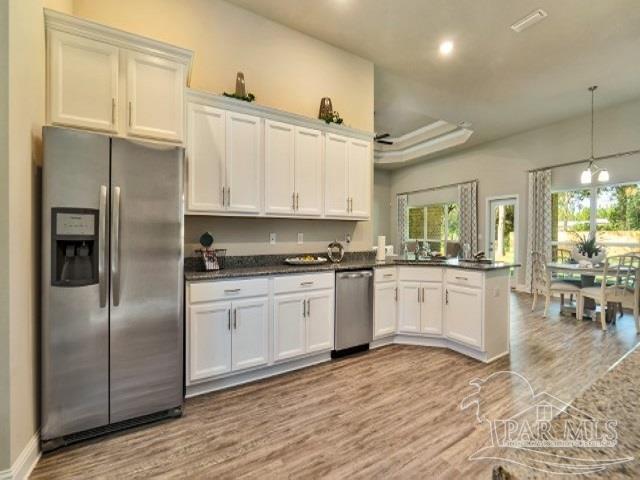 5636 Blake Lane Milton, FL 32571 - Photo 7 of 27 a kitchen with granite countertop a refrigerator stove top oven and sink