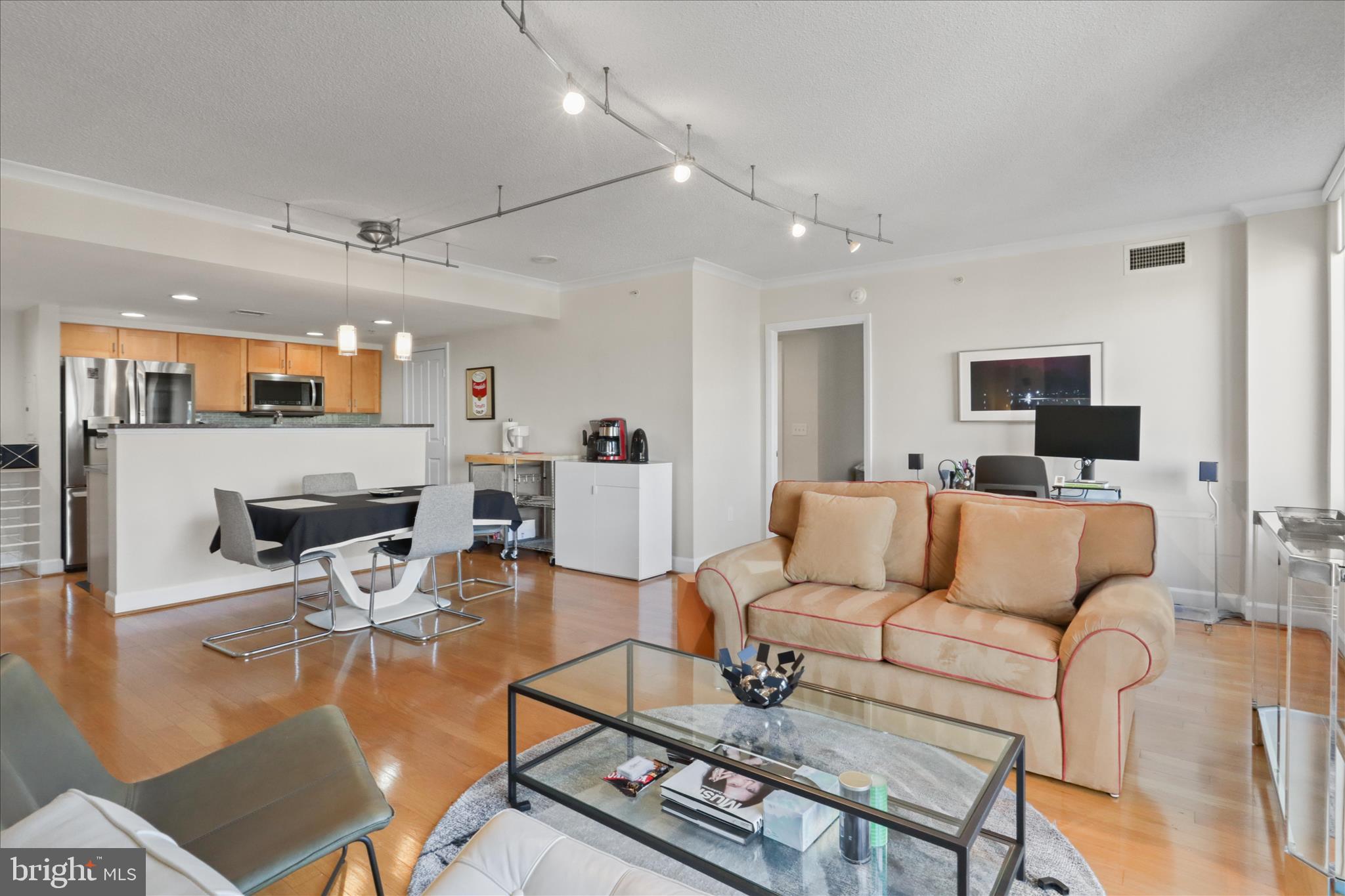1220 North Fillmore Street, Unit 909 Arlington, VA 22201 - Photo 37 of 38 a living room with furniture a flat screen tv and kitchen view