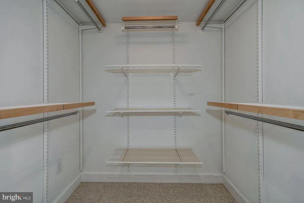 1220 North Fillmore Street, Unit 909 Arlington, VA 22201 - Photo 15 of 38 a view of walk in closet with empty racks
