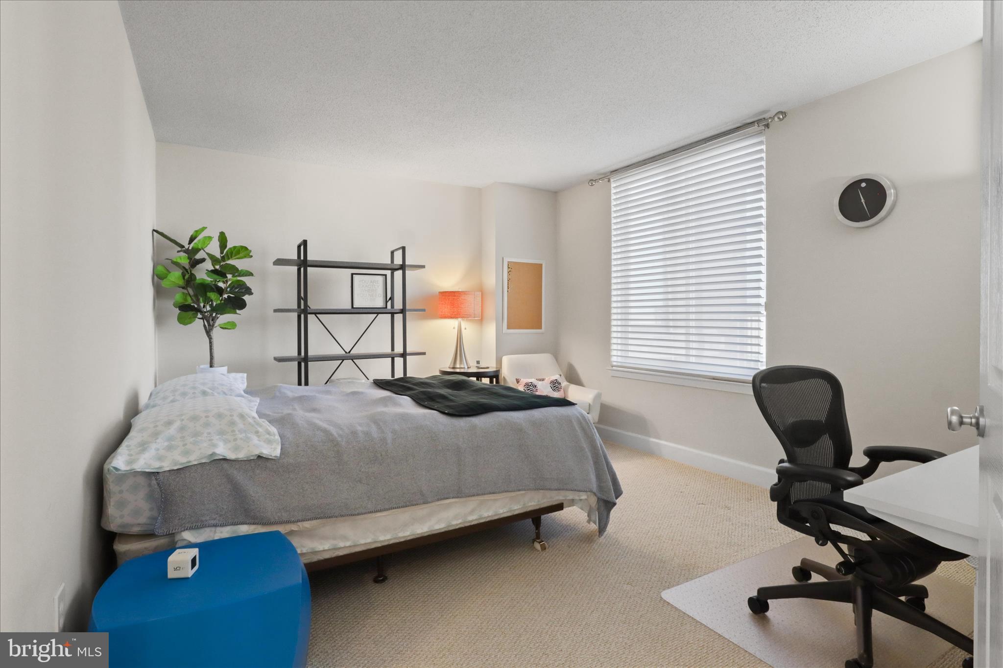 1220 North Fillmore Street, Unit 909 Arlington, VA 22201 - Photo 17 of 38 a bedroom with a bed and a potted plant