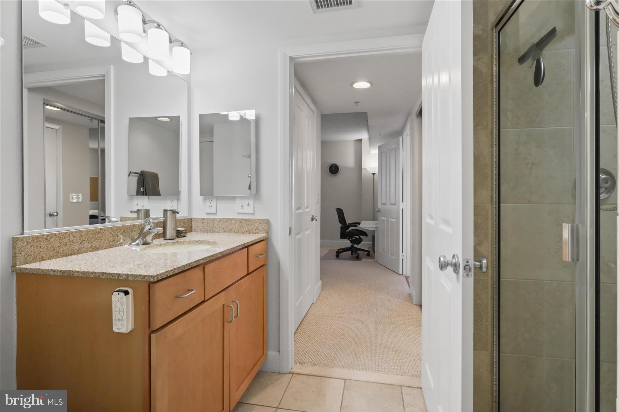 1220 North Fillmore Street, Unit 909 Arlington, VA 22201 - Photo 18 of 38 a en suite bathroom with a sink and a mirror