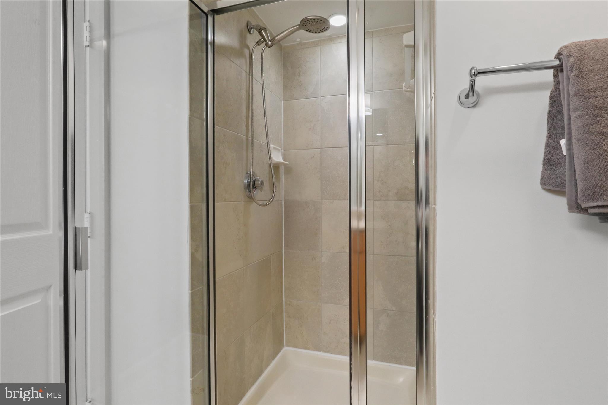 1220 North Fillmore Street, Unit 909 Arlington, VA 22201 - Photo 19 of 38 a bathroom with a shower and a glass door