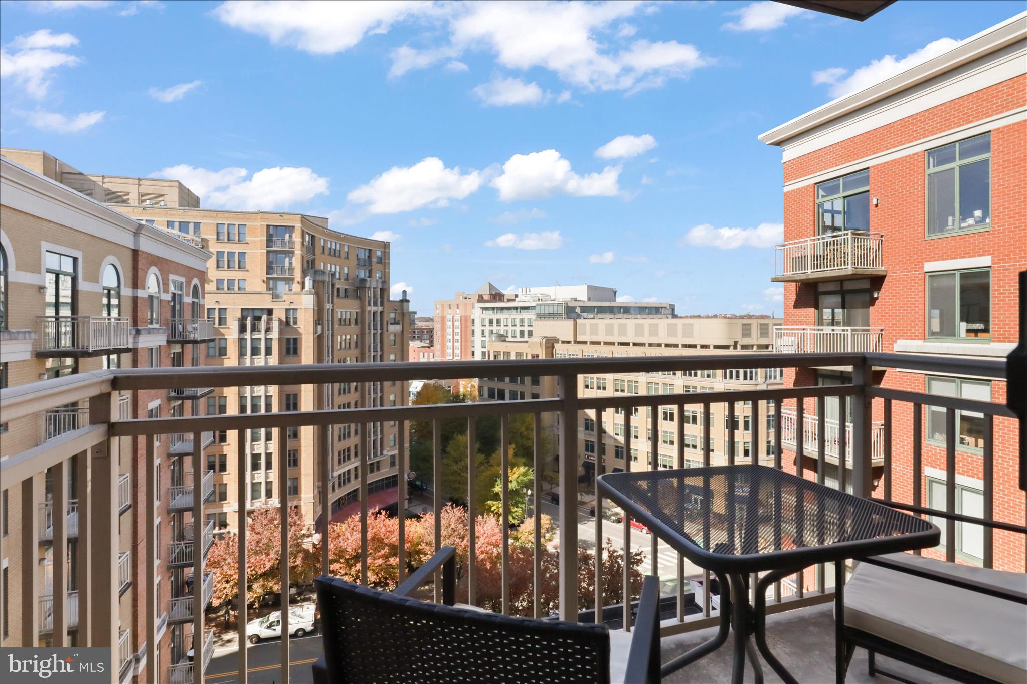 1220 North Fillmore Street, Unit 909 Arlington, VA 22201 - Photo 21 of 38 a view of a balcony with wooden chairs
