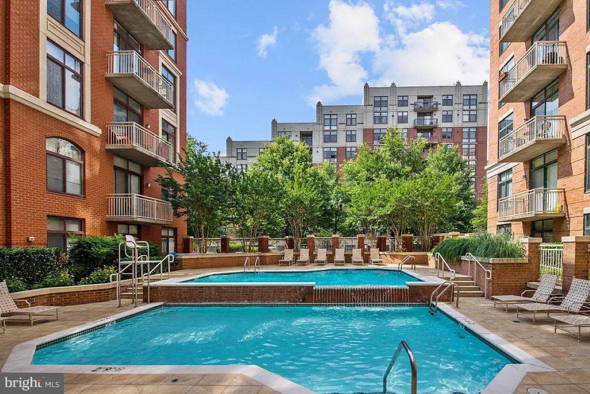 1220 North Fillmore Street, Unit 909 Arlington, VA 22201 - Photo 22 of 38 a building view with swimming pool and lawn chairs