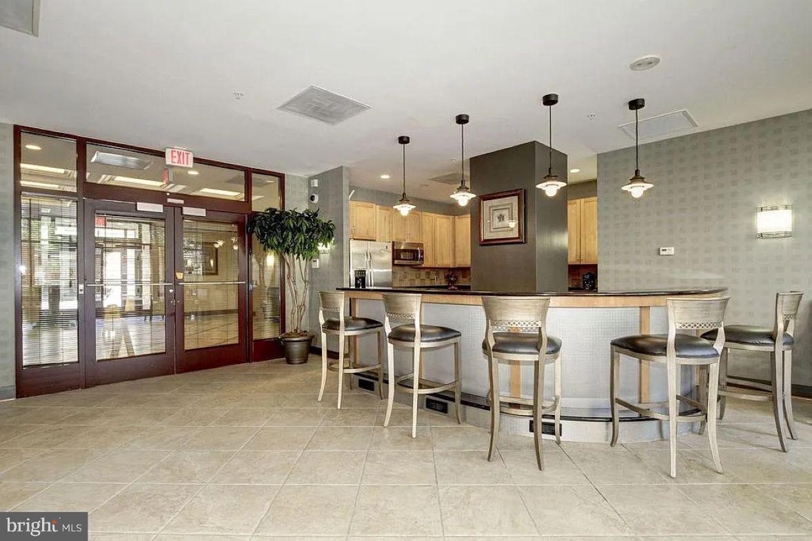 1220 North Fillmore Street, Unit 909 Arlington, VA 22201 - Photo 23 of 38 a large kitchen with a table and chairs