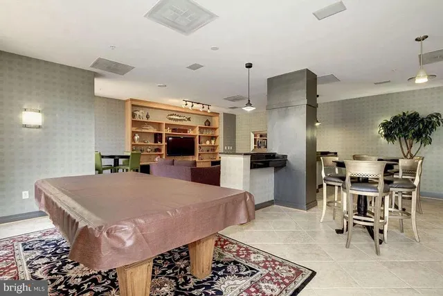 a large kitchen with a table and chairs