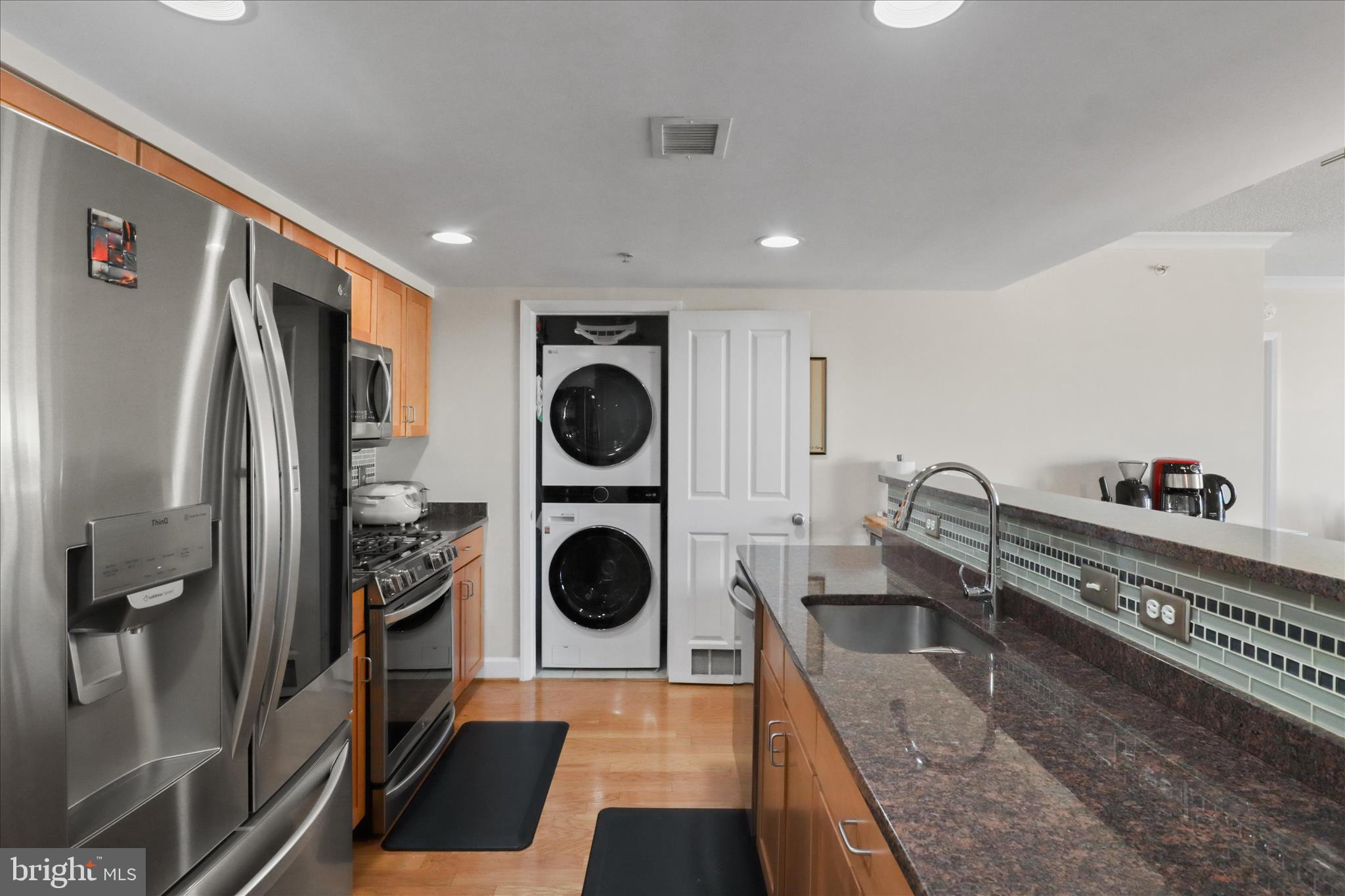 1220 North Fillmore Street, Unit 909 Arlington, VA 22201 - Photo 6 of 38 a kitchen with a refrigerator a sink and cabinets