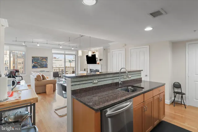 a kitchen with stainless steel appliances granite countertop a stove and a sink