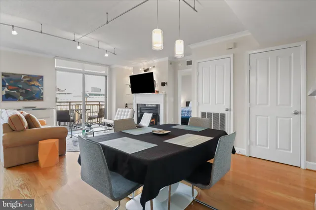a view of a a dining room with furniture window and wooden floor