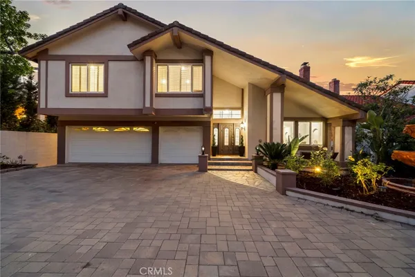 a view of a house with a patio and a yard
