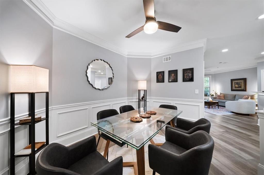 4100 Paces Walk Southeast, Unit 1101 Atlanta, GA 30339 - Photo 5 of 36 a living room with furniture a window and a clock