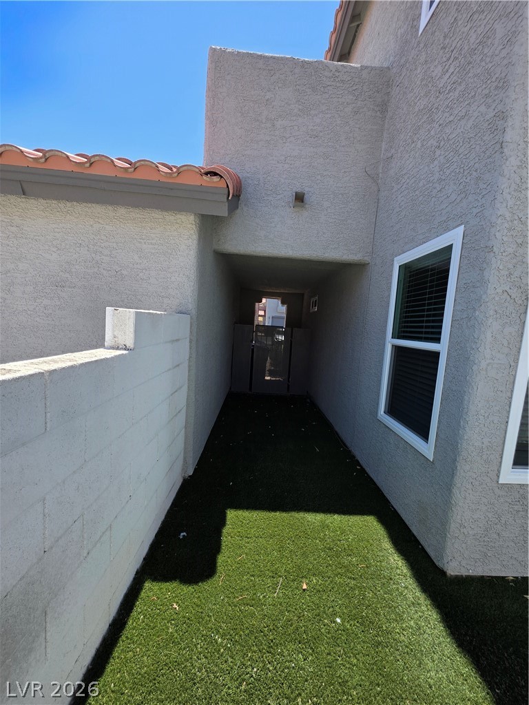 2275 Ramsgate Drive Henderson, NV 89074 - Photo 16 of 84 A well-maintained side yard with artificial turf offers a low-maintenance outdoor area.