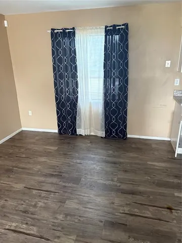 a view of room with stairs and wooden floor