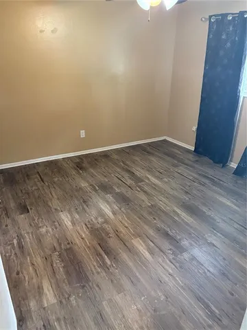 a view of room with wooden floor