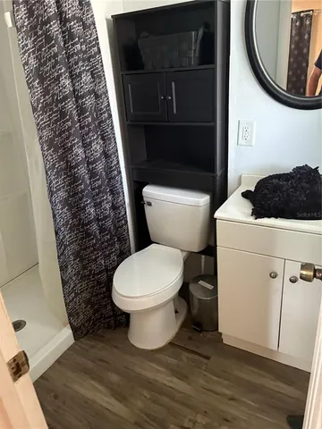 a bathroom with a toilet and a shower curtain