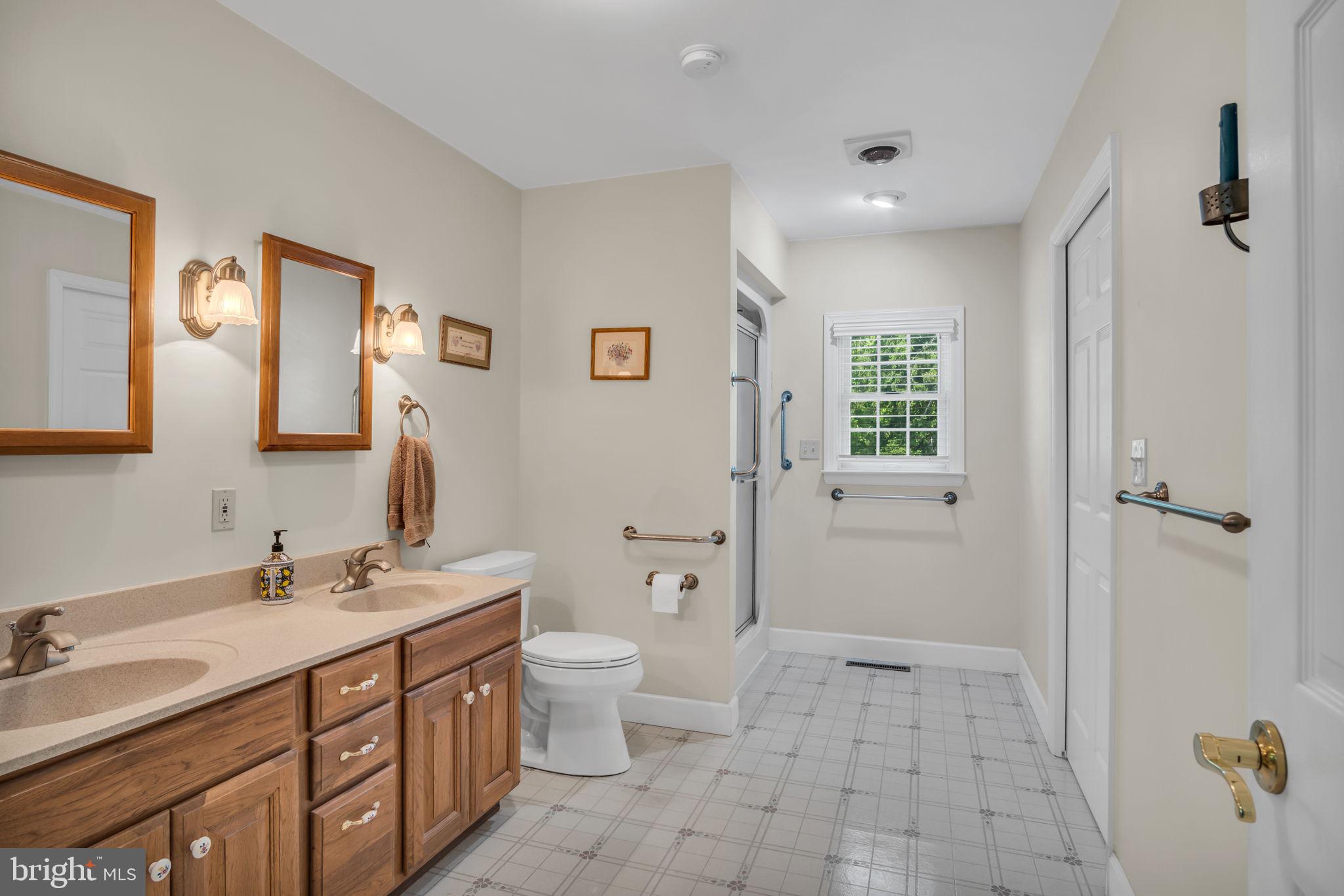 1037 Siddonsburg Road Lewisberry, PA 17339 - Photo 18 of 61 a spacious bathroom with a double vanity sink a toilet and a large mirror