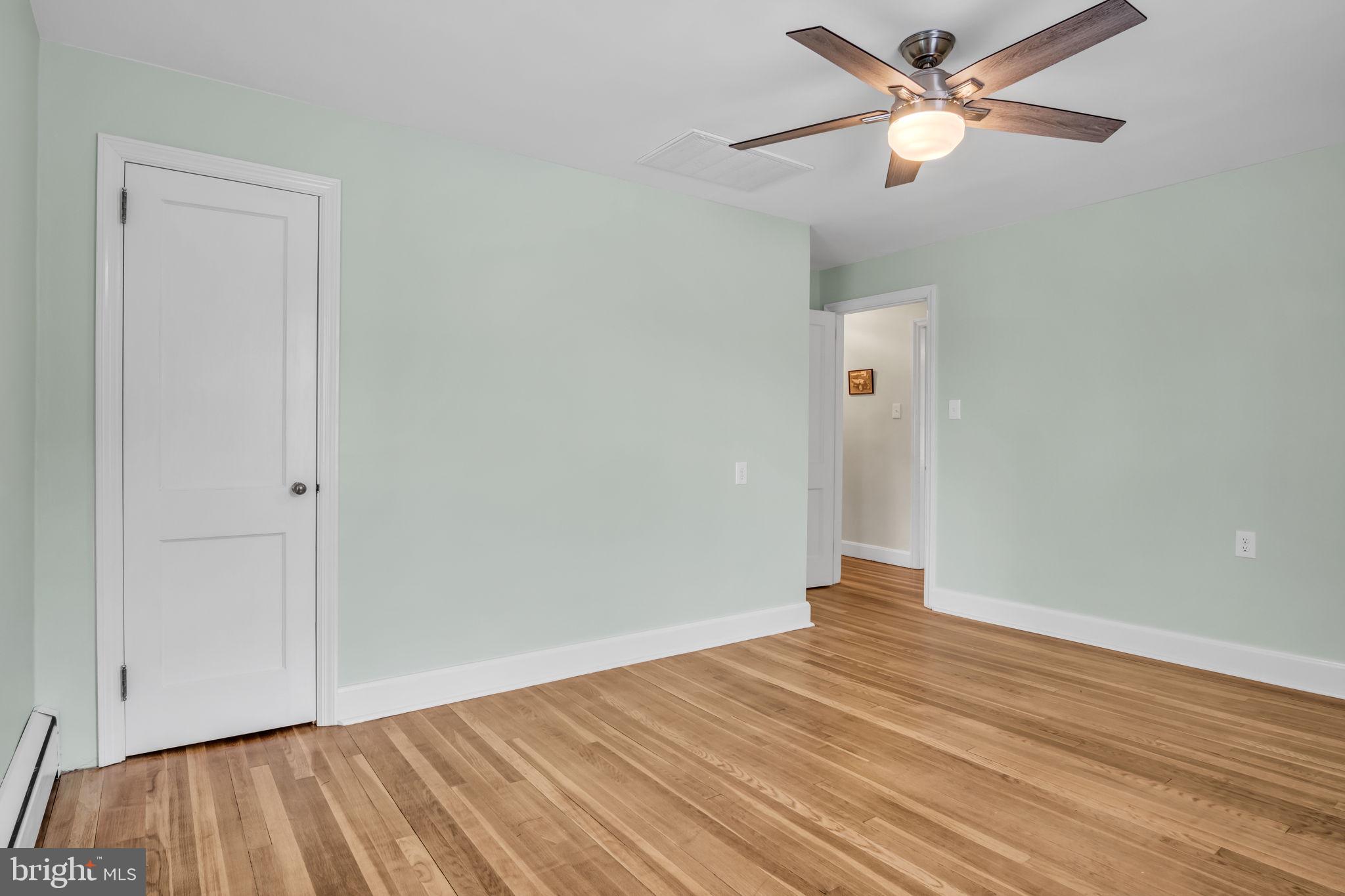 1037 Siddonsburg Road Lewisberry, PA 17339 - Photo 26 of 61 an empty room with wooden floor and a ceiling fan