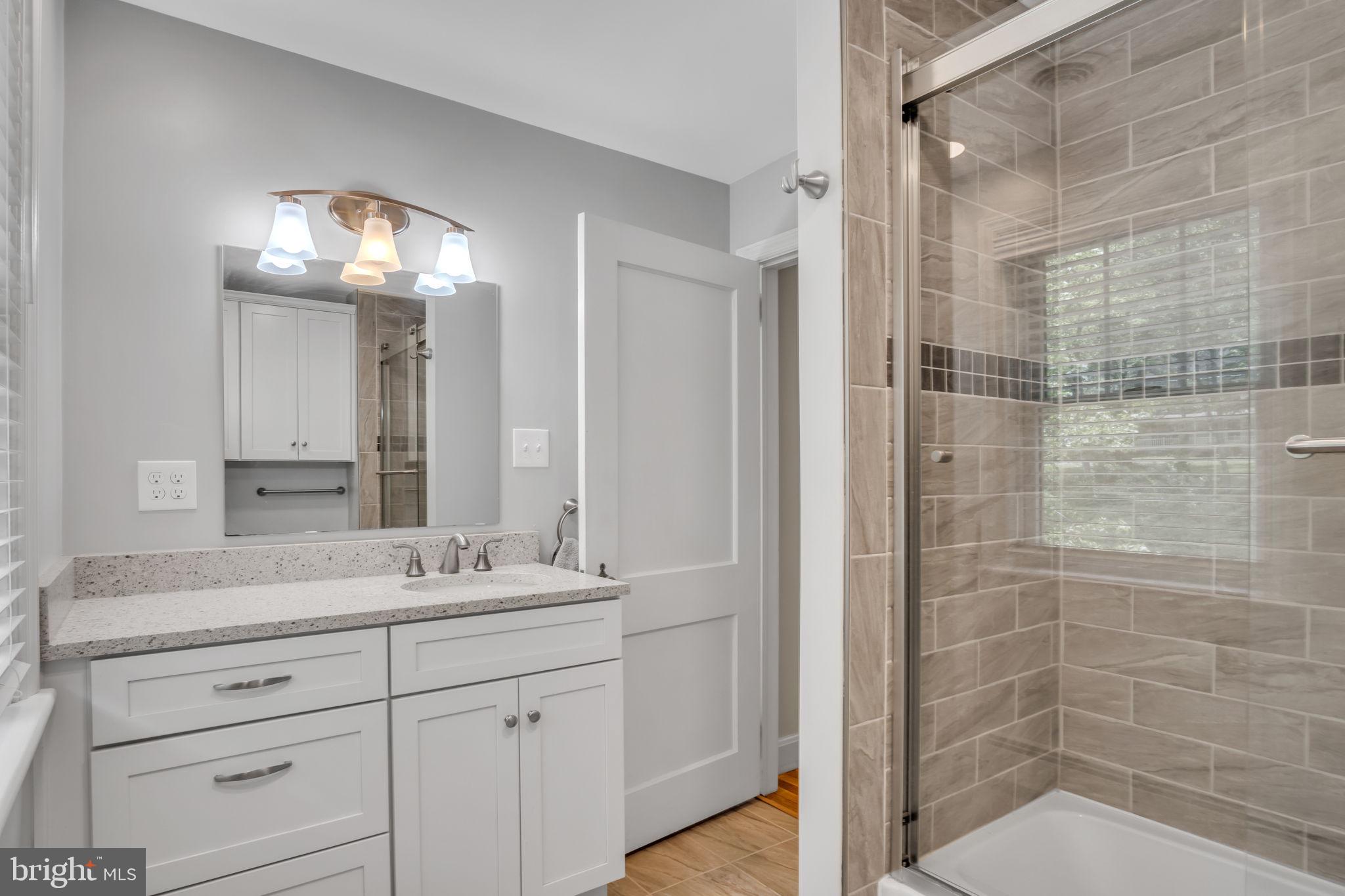 1037 Siddonsburg Road Lewisberry, PA 17339 - Photo 27 of 61 a bathroom with a sink a light fixture and a glass door shower