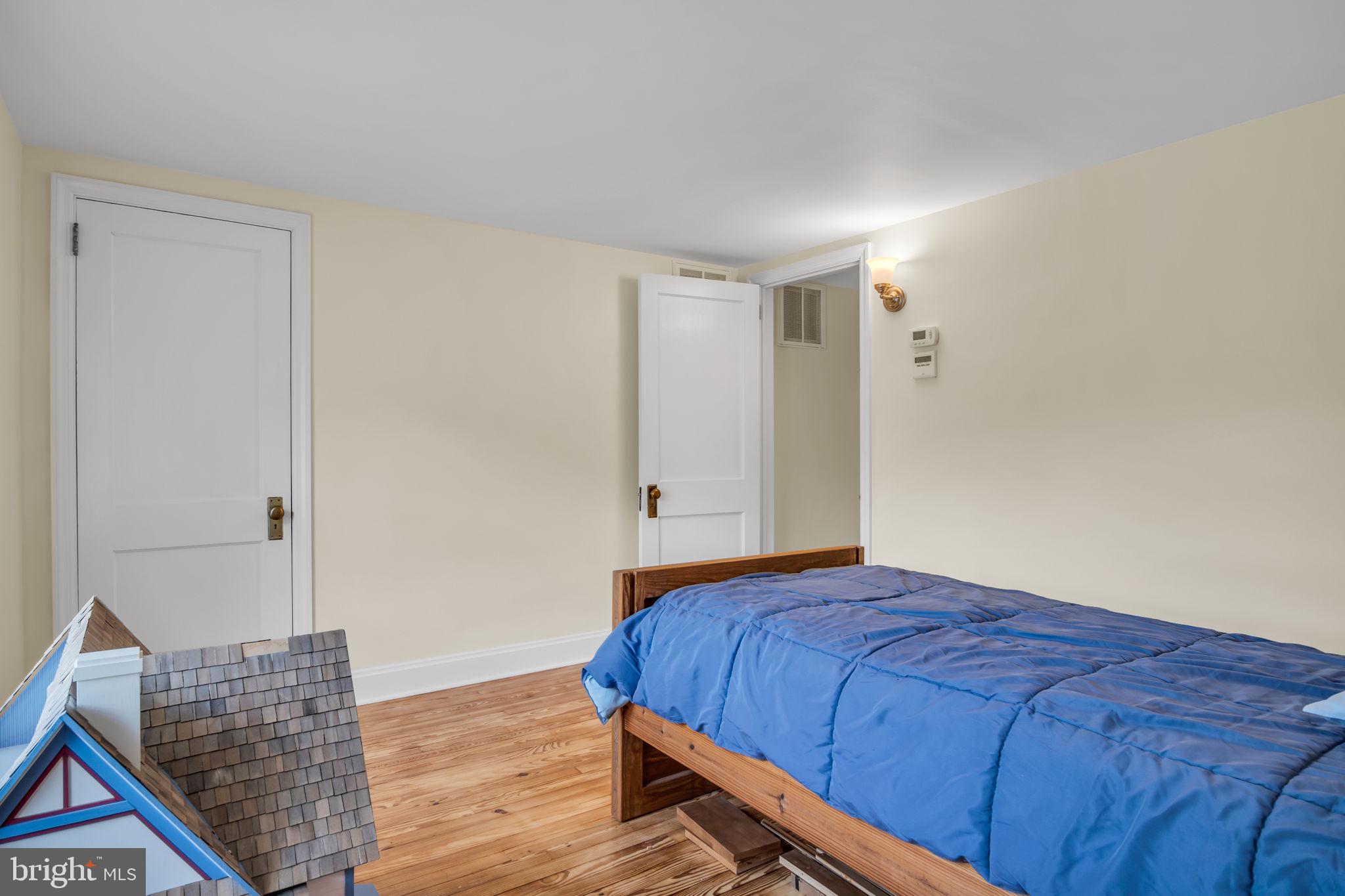 1037 Siddonsburg Road Lewisberry, PA 17339 - Photo 29 of 61 a bedroom with a bed and wooden floor
