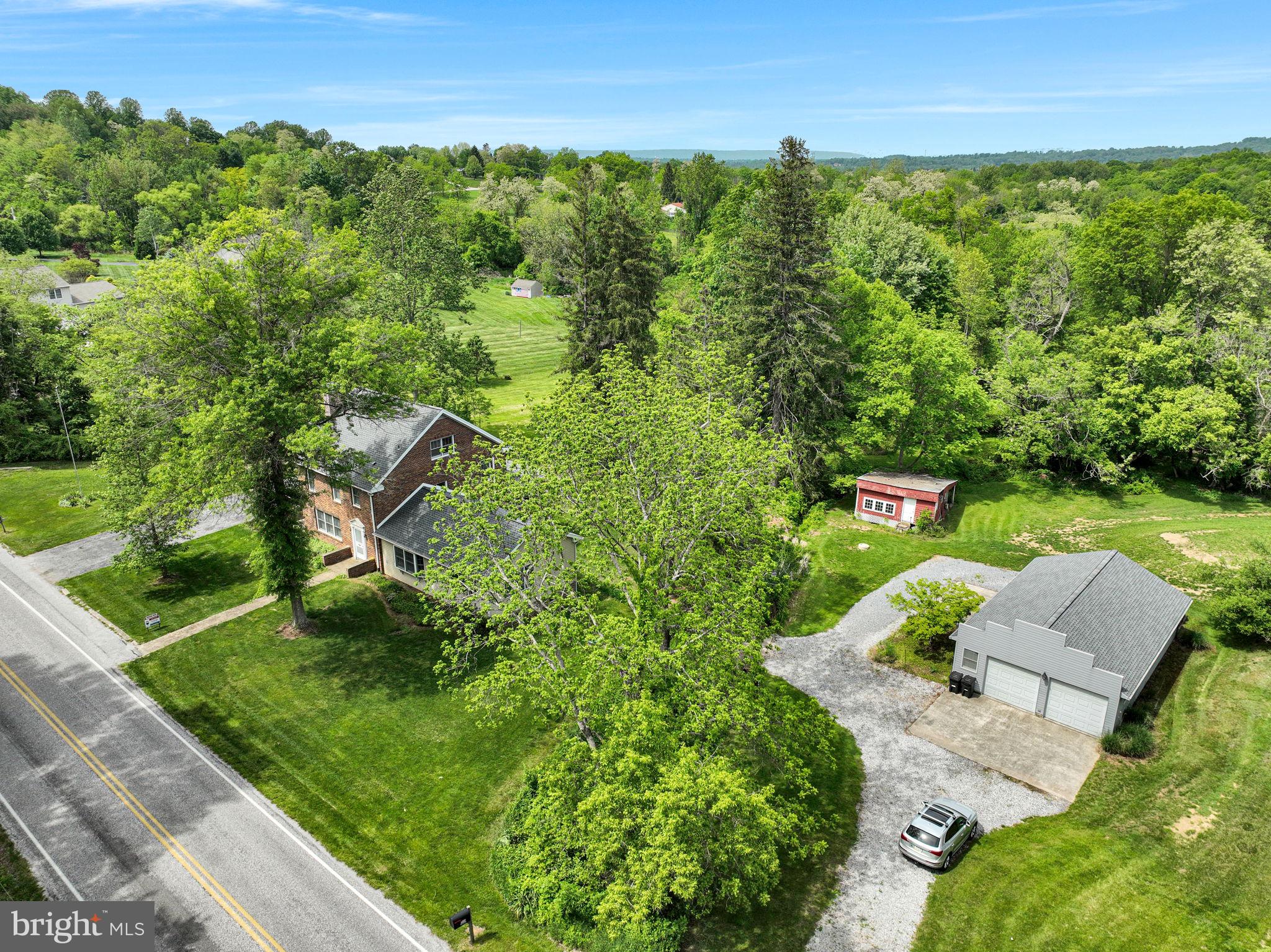 1037 Siddonsburg Road Lewisberry, PA 17339 - Photo 41 of 61 a view of a garden with a building in the background