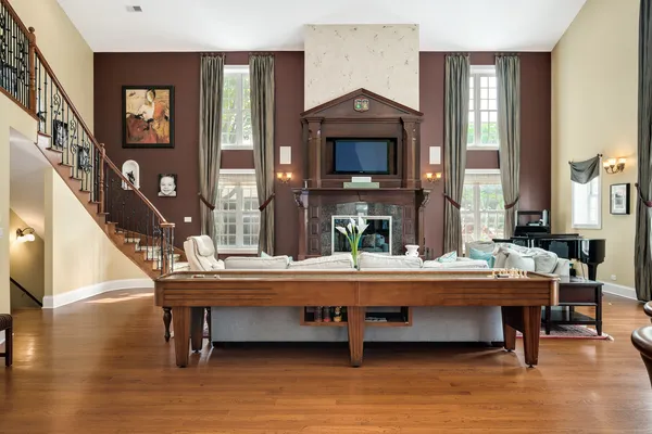 a living room with fireplace furniture and a large window