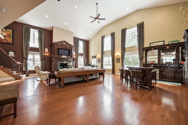a living room with furniture and floor to ceiling windows