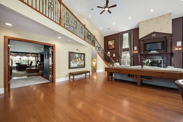 a living room with furniture a flat screen tv and a refrigerator
