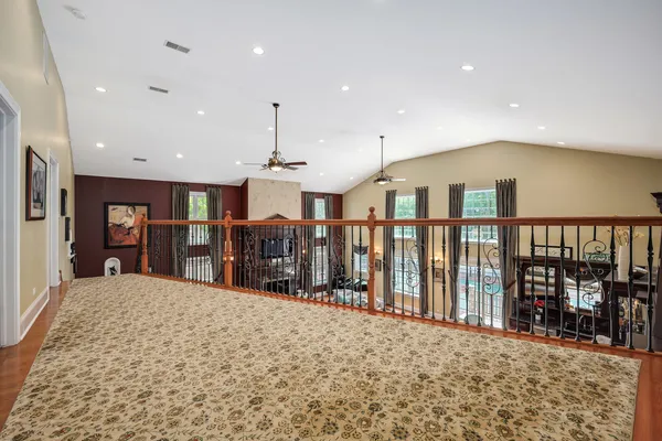 a spacious bathroom with a tub sink and mirror
