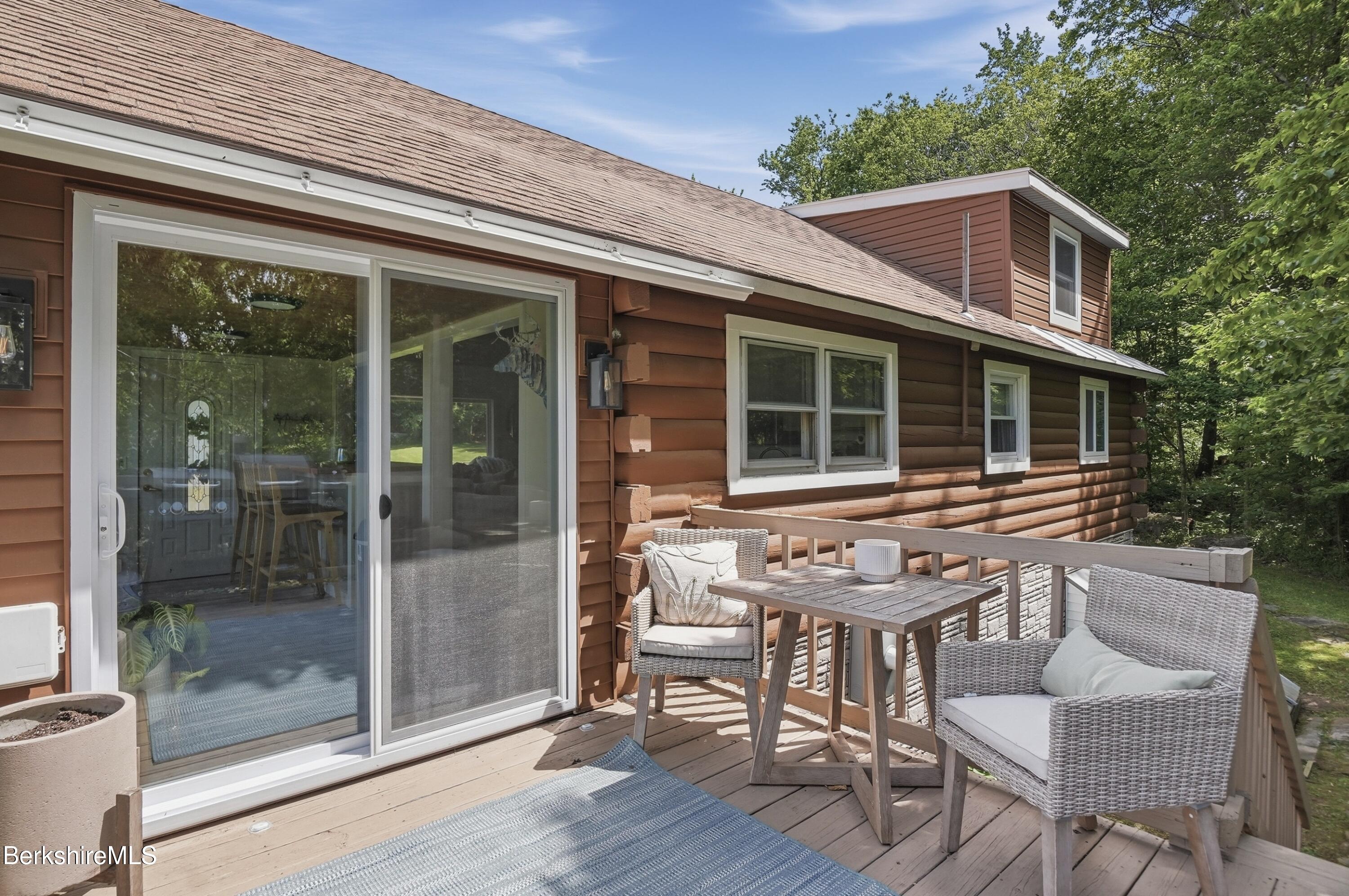 4 David Drive Peru, MA 01235 - Photo 35 of 44 a front view of a house with a porch and a table and chairs